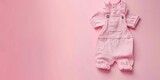 Fototapeta  - Baby girl clothes on pink pastel background. Fashion newborn clothes. Flat lay, top view. Copy space. Baby kids cotton clothing set. Infant bodysuit made of organic eco friendly cotton. Girl, daughter