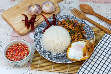 Wall Mural - Traditional Thai street food, stir-fried minced pork with basil, chili and garlic, served with fried egg