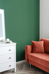 Wall Mural - Vertical shot of living room with red couch, white classic commode against green wall