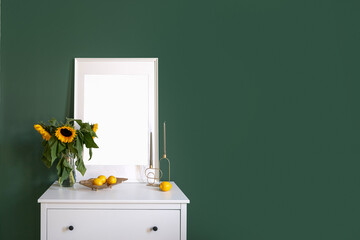 Wall Mural - White commode with picture and vase with flowers against green wall in bedroom