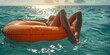 young woman sunbathing on an orange air mattress in swimsuit 