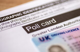 Fototapeta Londyn - London. UK- 03.29.2024. An official poll card for the Greater London Authorities elections and a UK photo driving licence as prove of identity.