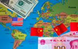 Fototapeta Londyn - A geopolitical economy, global north, global south, concept with US dollars and flag, Chinese yuan and flags over the northern and southern parts of a world map.