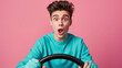 A man in a turquoise shirt is gripping a steering wheel with a shocked expression.