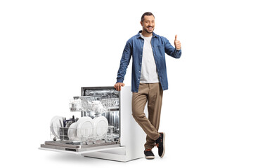 Wall Mural - Guy leaning on a dishwasher and gesturing thumbs up