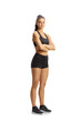 © Ljupco Smokovski - Full length portrait of a fit young woman in black crop top and shorts posing with folded arms
