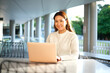 © Austockphoto - Lone woman working on laptop in seated area