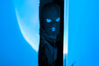 Masked intruder man peeking inside room suspiciously