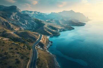 Wall Mural - Majestic mountain road winding through breathtaking coastal landscape, aerial nature photography