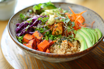  Vegetarian bowl bowl  with  quinoa, avocado, grilled tofu, pumpkin,  and microgreens on top. Plant based diet, healthy eating. AI Generated
