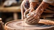 A potters wheel spins as wet clay is shaped by skilled hands