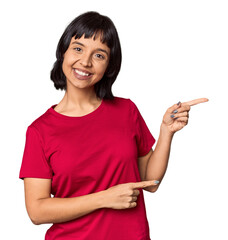 Poster - Young Hispanic woman with short black hair in studio excited pointing with forefingers away.