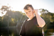 © Austockphoto - Teen boy standing in golden afternoon light with serious expression