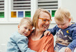 © Austockphoto - Mother with her two young sons out the front of her house