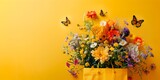 Fototapeta Natura - Yellow bag with flowers and butterflies on bright yellow background. Gardening, spring is here, summer beginning or mother's day concept, flat lay mockup banner with copy space.
