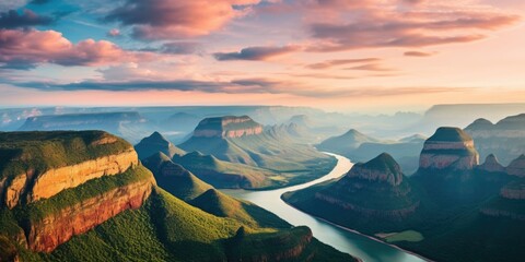 Wall Mural - A beautiful mountain range with a river running through it. The sky is a mix of blue and pink