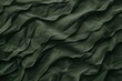   A detailed view of a green fabric, featuring undulating lines at its upper and lower edges