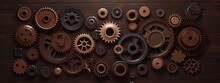 Rusty And Shiny Metal Steampunk Gears Of Different Sizes On A Wooden Background