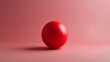 Red stress ball on pink background depicting relaxation, therapy, and anxiety relief