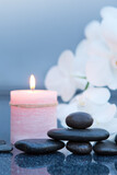 Fototapeta Na sufit - Spa background with white orchid , candle and zen black stones on gray.