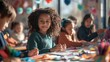 © MD Media - A diverse group of happy children sitting at a table in art class, painting and creating with paper collage and craft materials.