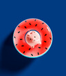 Piggy bank with Watermelon inflatable rubber ring on vibrant blue background. Savings for summer vacation. 3D Rendering, 3D Illustration