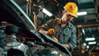 auto car engineer doing work, car engineer at the workstation with yellow helmet, hard worker at work