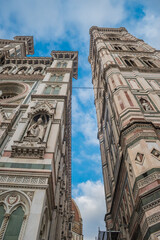 Wall Mural - Detail of the facade of the Cathedral Santa Maria del Fiore next to the Giotto bell tower and Duomo in the background, Florence ITALY