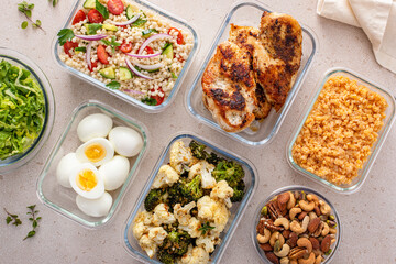 Wall Mural - Healthy meal prep with cooked chicken breast, boiled eggs, roasted vegetables, cooked lentils, couscous salad and nuts