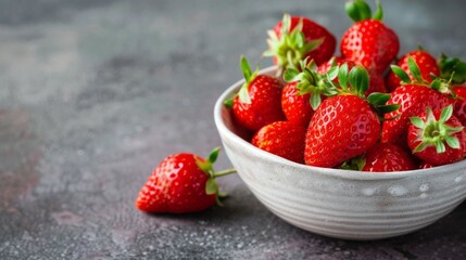 Wall Mural - Fresh strawberries in a ceramic bowl with ripe red berries and a sweet juicy texture
