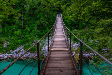 Wall Mural - wooden bridge over soca river in Slovenia