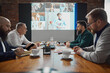 © master1305 - Business leaders sitting conference room, having online video call with employees, promoting seamless communication and collaboration across distances. Concept of business, teamwork, cooperation