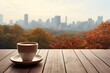 Coffee cup and autumn leaves on wooden table with city view background