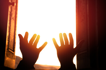 Sticker - Hands raised in prayer towards the light, spiritual concept, stock photo