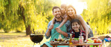 Fototapeta Panele - Happy family having picnic on summer day