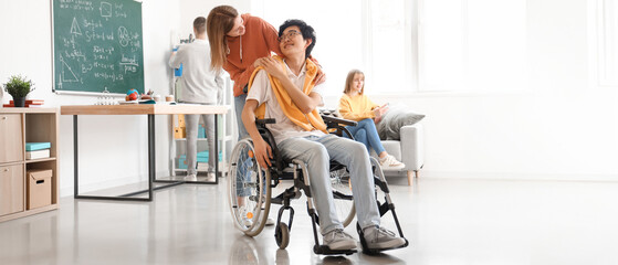 Canvas Print - Teenage girl with her classmate in wheelchair at school