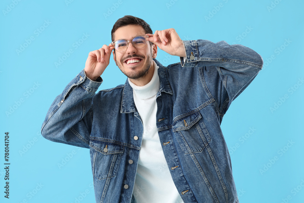 Young man in eyeglasses on blue background