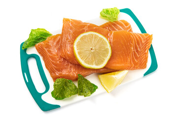 Wall Mural - Top down view of pieces of Salmon filet on a white cutting board ready to be cooked isolated on white