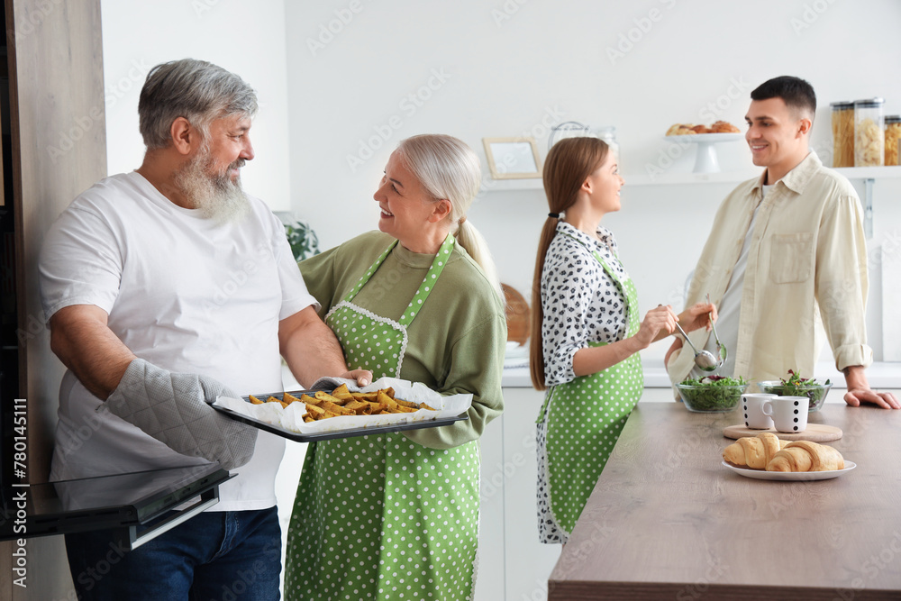 Mature couple with baked potato in kitchen
