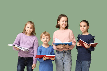 Canvas Print - Little children reading books on green background