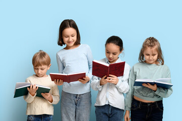 Canvas Print - Little children reading books on blue background