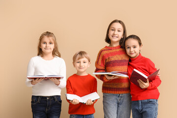 Poster - Little children reading books on beige background