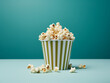 Popcorn nestled in a paper cup against blue and green