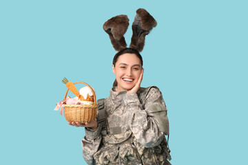 Poster - Happy female soldier in bunny ears with Easter basket on blue background