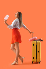 Sticker - Young businesswoman with passport and suitcase ready for summer vacation on orange background