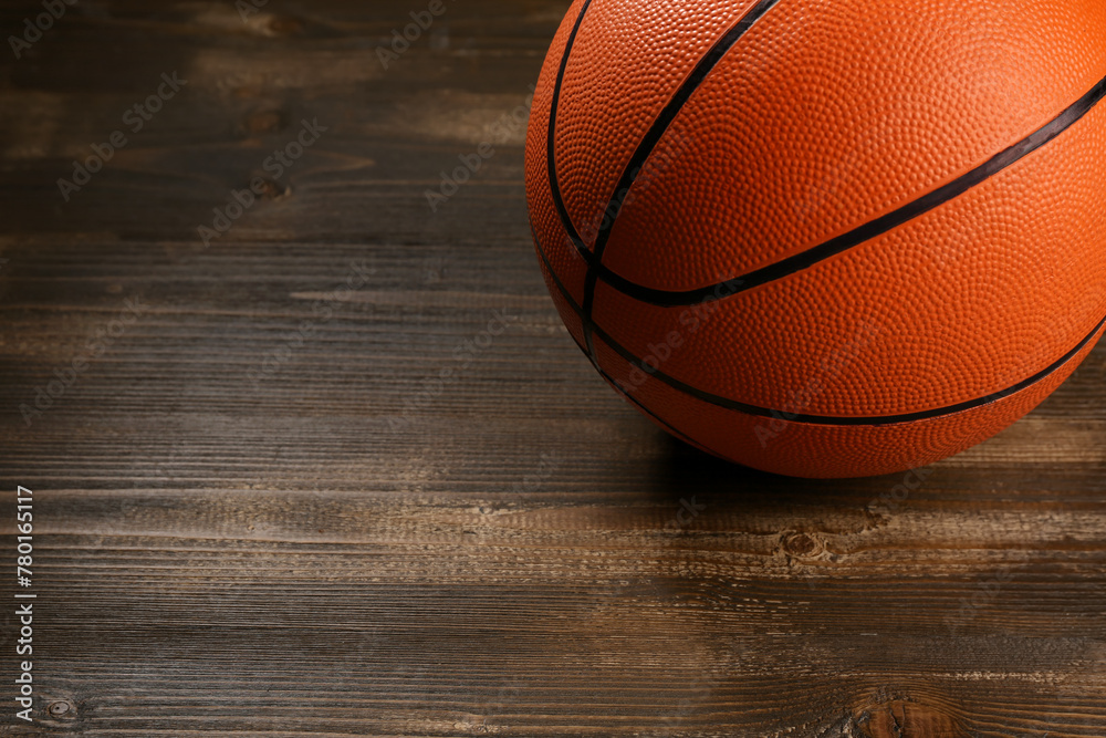 Ball for playing basketball on wooden background, closeup