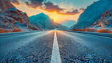 Fototapeta  - Serene Road Journey through Picturesque Countryside, Sunset Illuminating the Highway with Mountains in the Distance