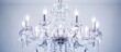 A luxurious crystal chandelier suspended from the ceiling, adorned with numerous glowing lights casting a warm and elegant glow
