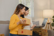 Two business owners are checking customer information on a package before it is delivered to the buyer, Two co-workers are checking that order data matches sales figures.
