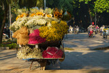 Fototapeta Dziecięca - Rear view of street flower vendor seller on bicycle in Old Quarter in Hanoi, Vietnam..